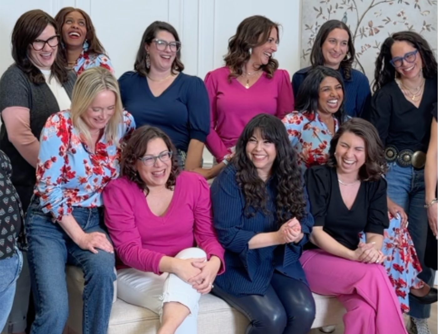 A group of Erapreneurs laughing together on a couch
