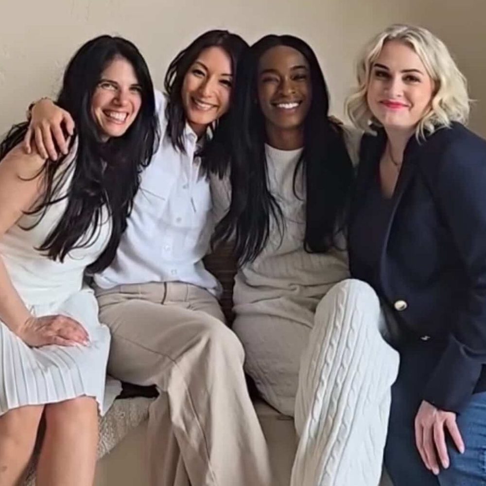Four Erapreneurs laughing together on a studio set